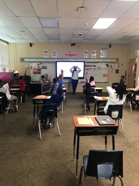 Awesome lesson moment!!!!  Dr. Wyche did a great job reviewing grammar/reading vocabulary using the game Heads Up!  Just look at the hands in the air!!!